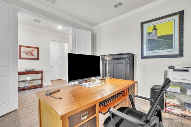 office space featuring baseboards, light wood-style flooring, visible vents, and crown molding