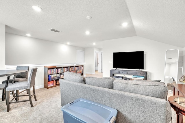 living room with light carpet, visible vents, vaulted ceiling, a textured ceiling, and recessed lighting