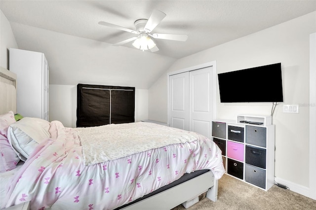 bedroom featuring ceiling fan, carpet floors, baseboards, vaulted ceiling, and a closet