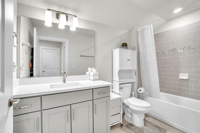 bathroom featuring a textured ceiling, toilet, vanity, tile patterned floors, and shower / bath combo