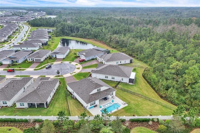 birds eye view of property featuring a water view, a residential view, and a view of trees