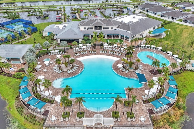 view of pool featuring a water view and a residential view