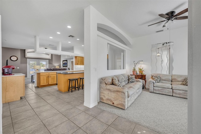 living area featuring light tile patterned floors, ceiling fan, visible vents, and recessed lighting