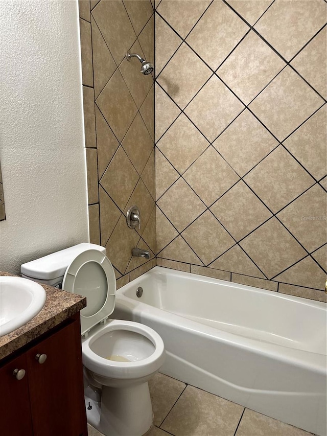 full bath featuring a textured wall, tile patterned flooring, toilet, vanity, and shower / washtub combination