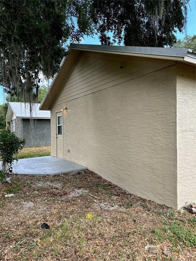 view of property exterior featuring a patio area and stucco siding