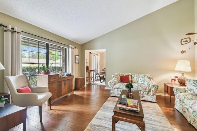 living room with lofted ceiling, a textured ceiling, dark wood-style floors, and baseboards