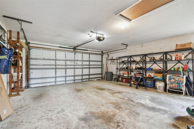 garage with a garage door opener and concrete block wall