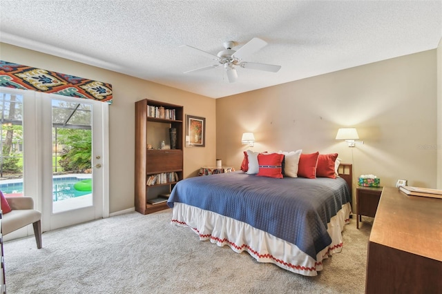 bedroom with a textured ceiling, a ceiling fan, light colored carpet, and access to exterior