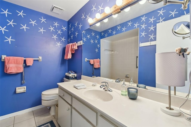 bathroom with toilet, vanity, visible vents, a tile shower, and tile patterned floors