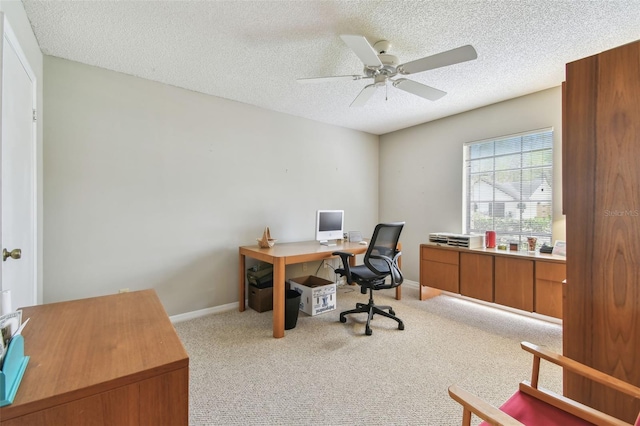 home office featuring a textured ceiling, baseboards, and light colored carpet