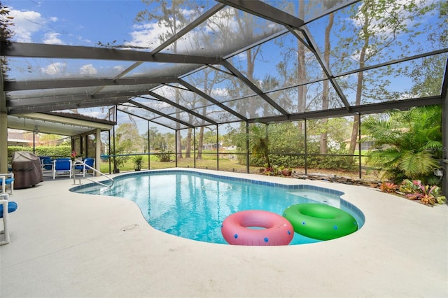 pool with glass enclosure and a patio