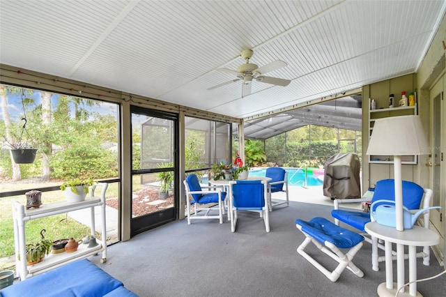 sunroom / solarium featuring ceiling fan