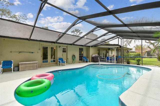 pool with a patio, french doors, a lanai, and a grill