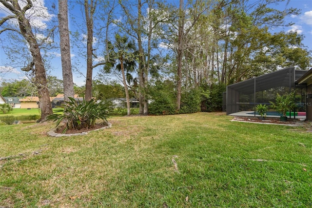 view of yard with glass enclosure