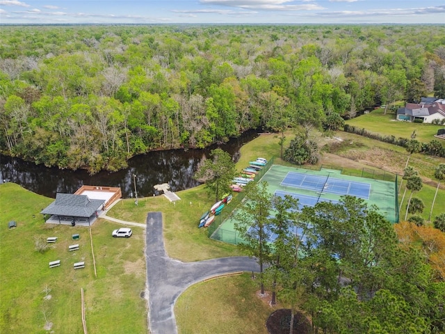 bird's eye view featuring a forest view and a water view