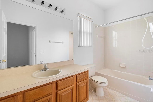 bathroom with toilet, vanity, and bathing tub / shower combination