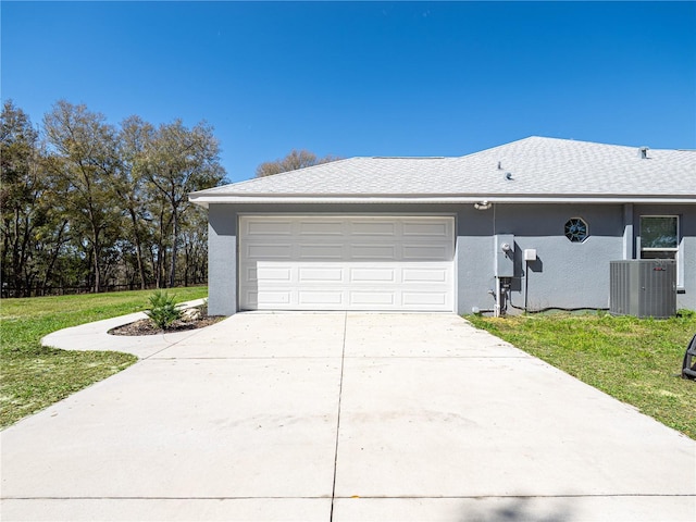 exterior space featuring stucco siding, a lawn, a garage, cooling unit, and driveway