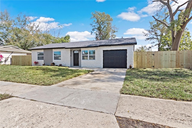 view of front of property featuring a garage, driveway, a front yard, and fence