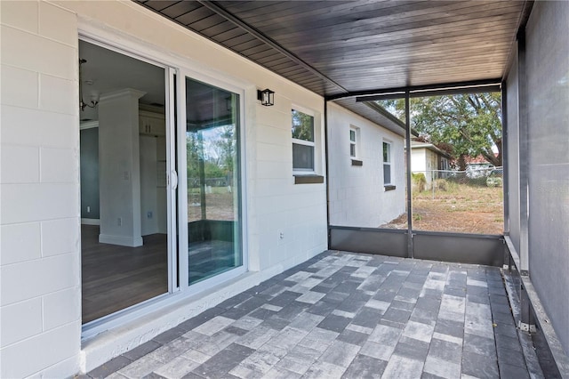 unfurnished sunroom with wood ceiling and a wealth of natural light