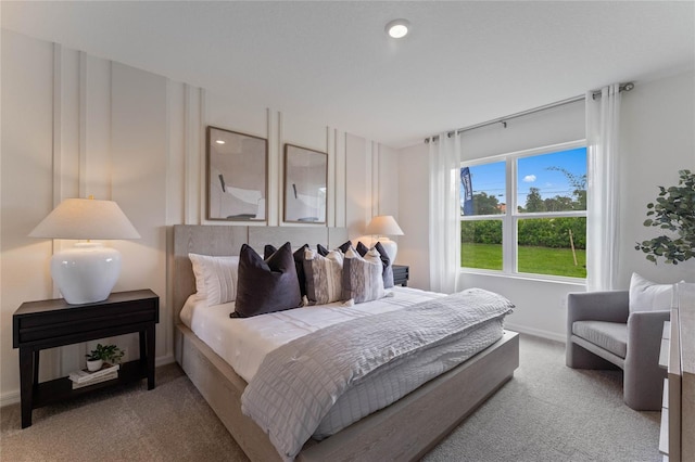 carpeted bedroom featuring baseboards