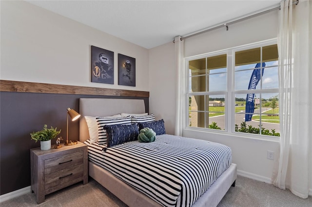 bedroom with carpet and baseboards