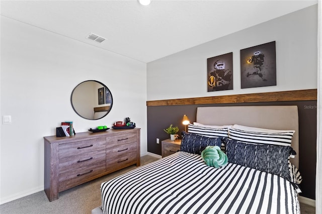 bedroom featuring baseboards, visible vents, and light colored carpet