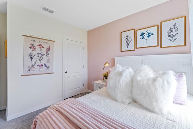 carpeted bedroom with visible vents and baseboards