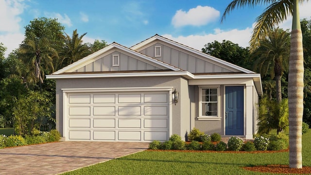 view of front of home with an attached garage, decorative driveway, stucco siding, a front lawn, and board and batten siding