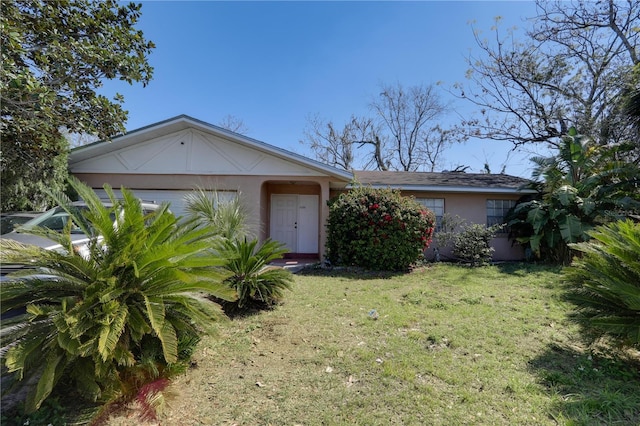 single story home with a front lawn and stucco siding