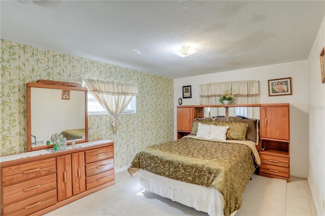 bedroom with a textured ceiling and wallpapered walls