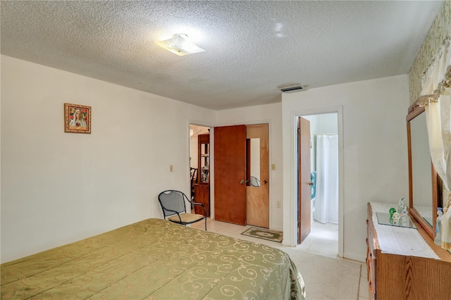 bedroom featuring visible vents and a textured ceiling