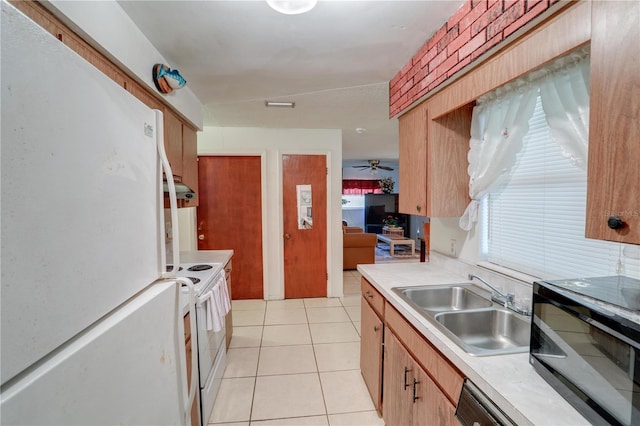 kitchen featuring white appliances, ceiling fan, light countertops, a sink, and light tile patterned flooring