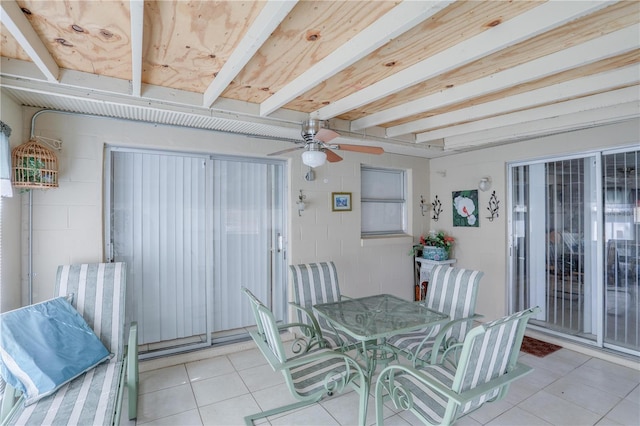 interior space featuring light tile patterned floors, a ceiling fan, and beam ceiling