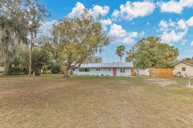 single story home featuring fence and a front lawn