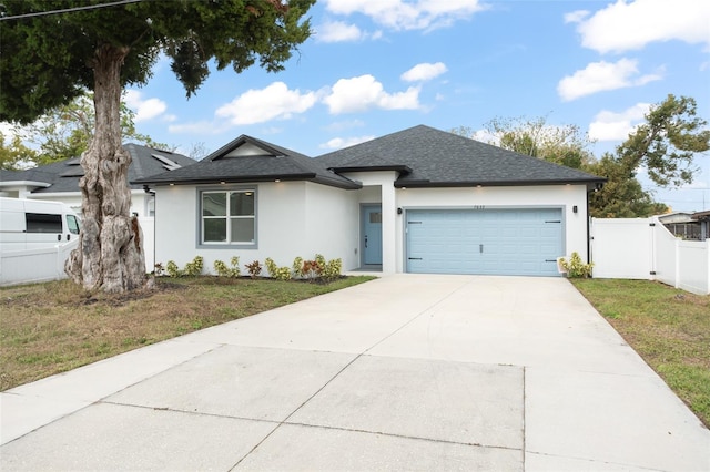 ranch-style home with driveway, a front lawn, an attached garage, and fence