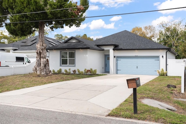 single story home featuring a garage, fence, concrete driveway, stucco siding, and a front yard