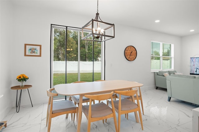 dining space featuring recessed lighting, marble finish floor, a notable chandelier, and baseboards