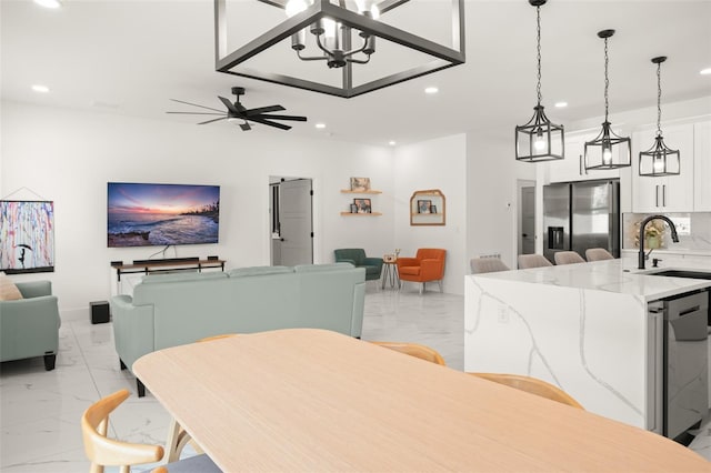 dining room featuring marble finish floor, a ceiling fan, and recessed lighting