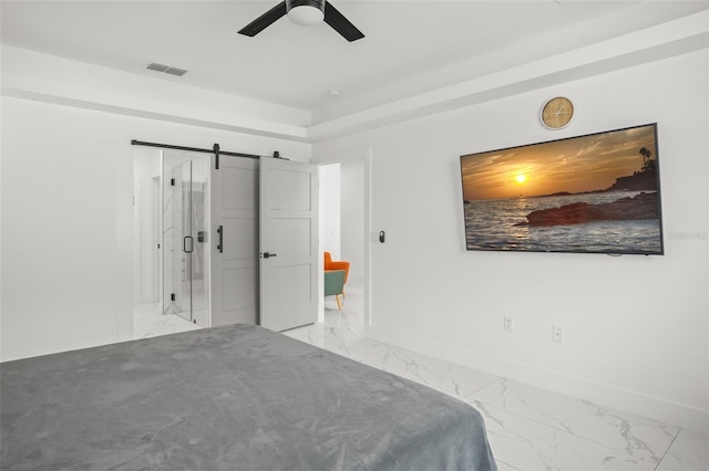 unfurnished bedroom featuring marble finish floor, visible vents, a barn door, ceiling fan, and baseboards