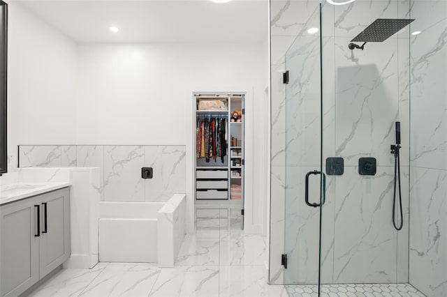 full bath with marble finish floor, a marble finish shower, a spacious closet, vanity, and a bath