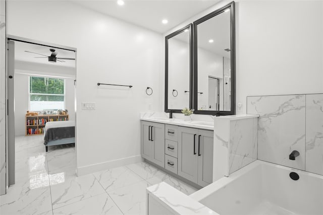 bathroom with recessed lighting, baseboards, marble finish floor, a bath, and double vanity