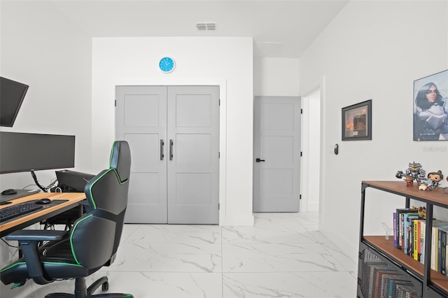 office area featuring marble finish floor and visible vents