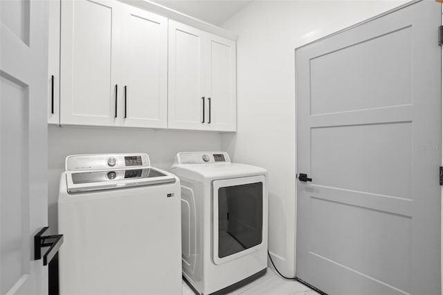 laundry area featuring cabinet space and separate washer and dryer