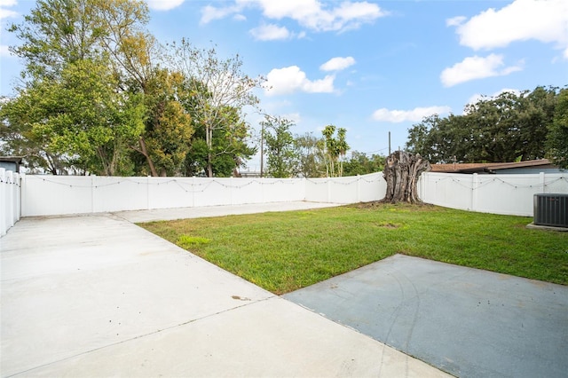 view of yard featuring a patio area, a fenced backyard, and central AC unit