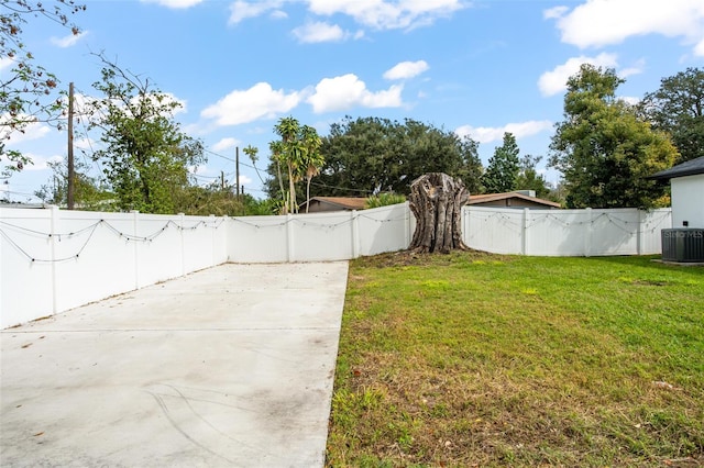 view of yard featuring cooling unit, a patio area, and a fenced backyard