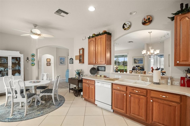 kitchen with a sink, visible vents, dishwasher, and brown cabinetry