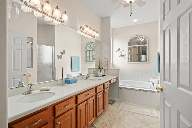 full bath with a sink, a garden tub, a shower stall, and tile patterned flooring