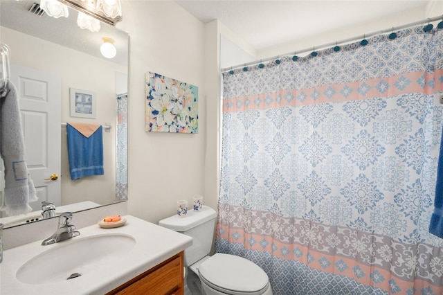 bathroom featuring vanity, curtained shower, toilet, and visible vents