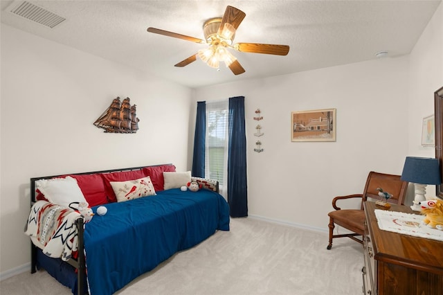 bedroom with light carpet, visible vents, ceiling fan, and baseboards