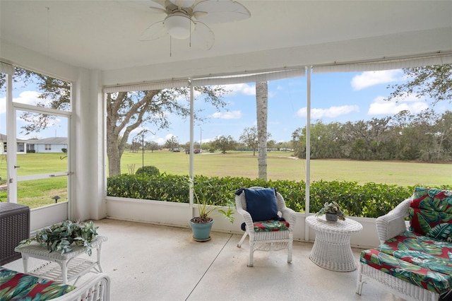 sunroom / solarium featuring ceiling fan